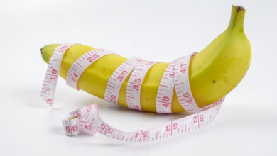 Banana with measuring tape. Menhealth concept